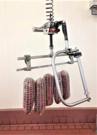 Manipuladores industriales INDEVA equipados con gancho de acero inoxidable para el manejo ergonómico y seguro de los jamones.