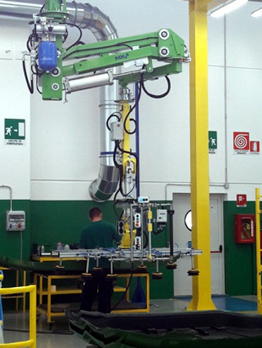 Handling large tractor sides in a production line using an overhead mounted intelligent lift assist device INDEVA Liftronic Air